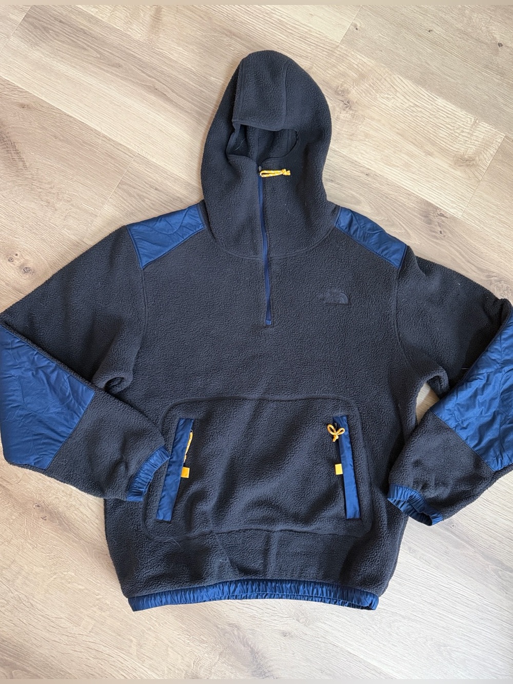 The North Face Black Fleece Hoodie with Blue Panels and Orange Accents